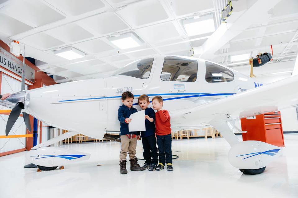 kids looking at a flight plan at an aviation museum