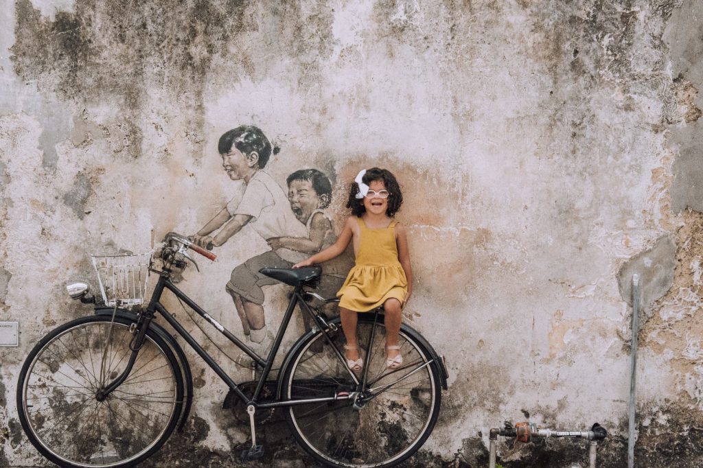 Nora on bike art in Penang